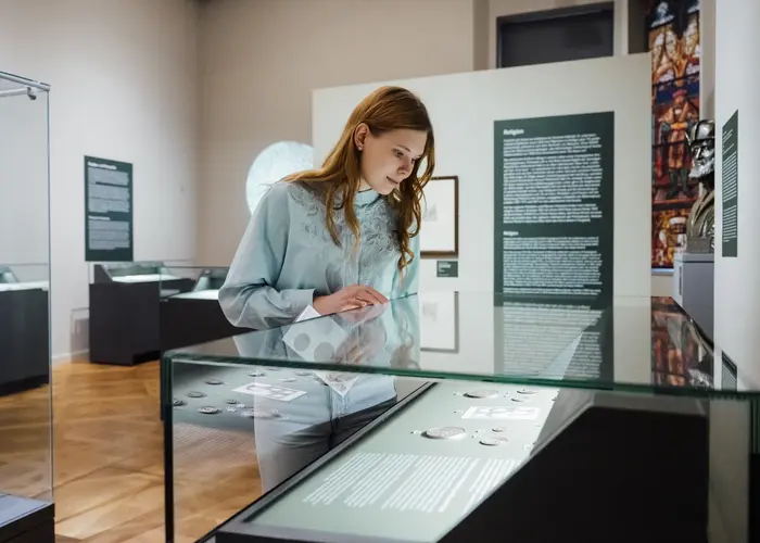Frau vor einer Vitrine im Ausstellungsraum